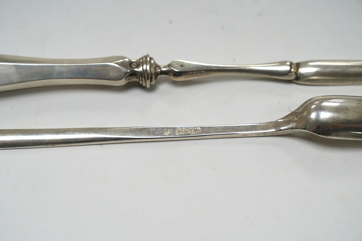 An Elizabeth II silver marrow scoop, by Francis Howard Ltd, Sheffield, 1977, 21.6cm, together with a Dutch 833 standard white metal marrow scoop. Condition - fair
